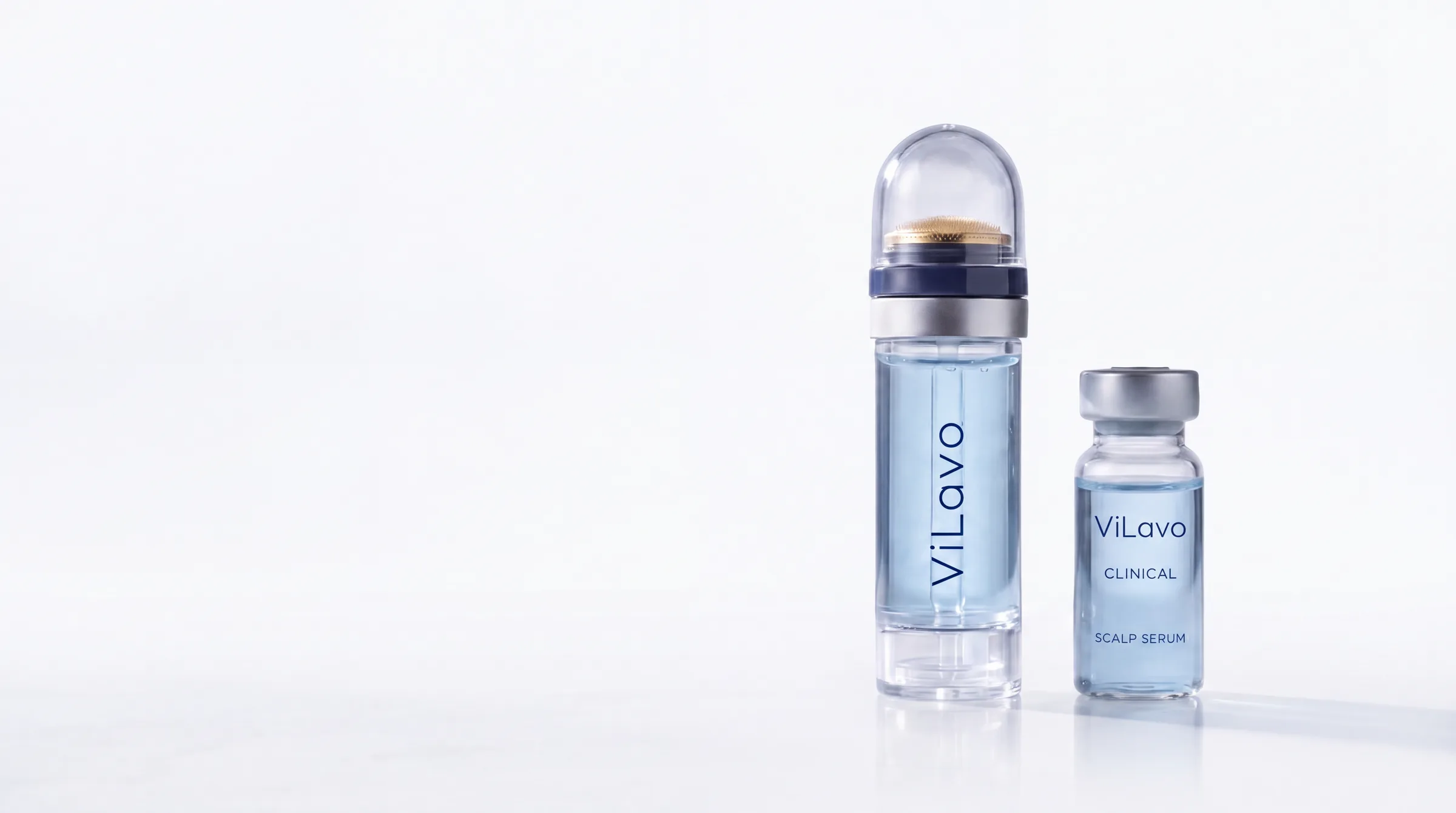 The ViLavo applicator and a vial of ViLavo scalp serum on a white studio background